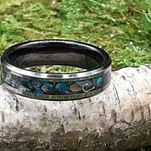 Dinosaur bone fragments and opal on black tungsten